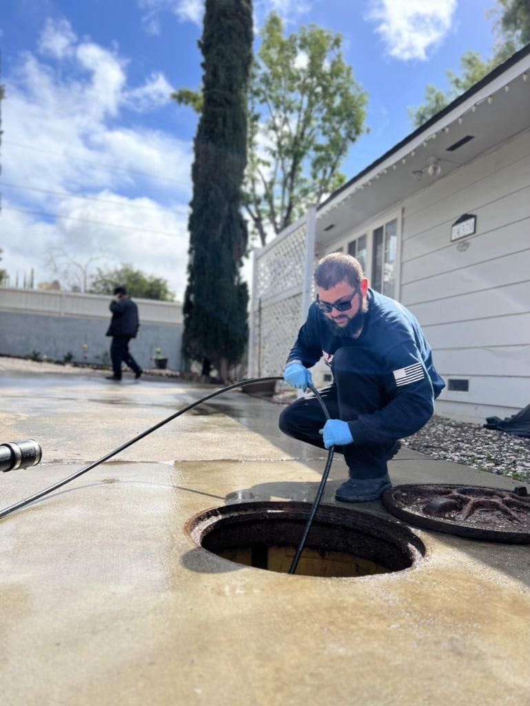 plumber clearing sewer line