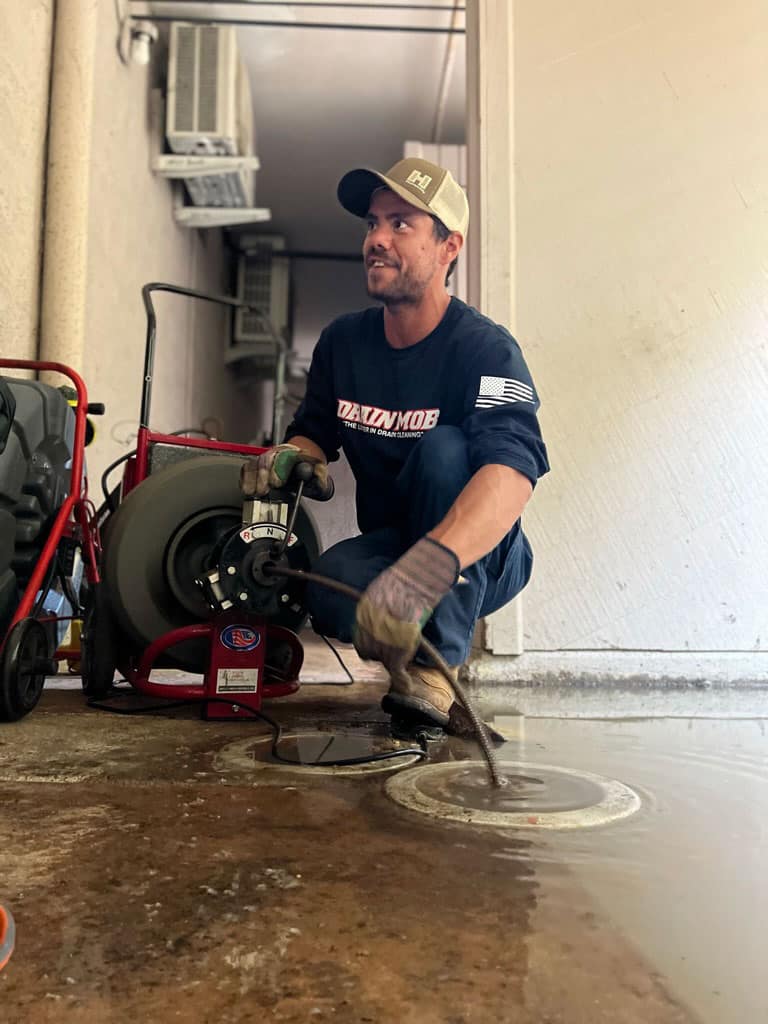 Drain Mob employee performing drain cleaning services